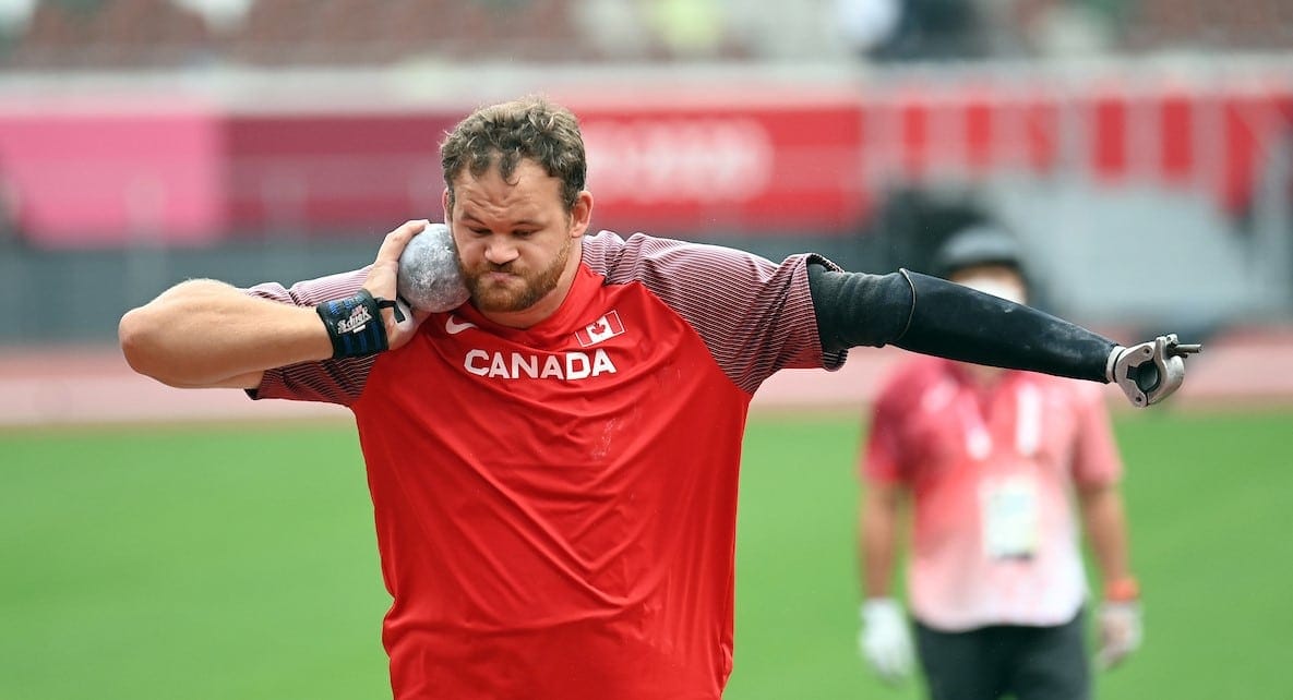 greg strewert in red canada jersey, throwing shot put
